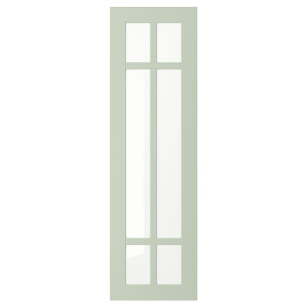 Une porte d’armoire vert clair STENSUND avec un design de panneau de verre hachuré.