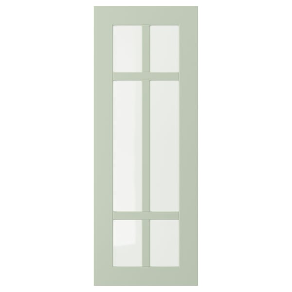 Porte d’armoire STENSUND vert clair avec panneaux de verre carrés.