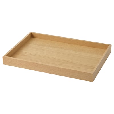 Un plateau en bois nommé STOCKHOLM 2025. Son rectangulaire, en chêne, a une finition brune naturelle. Idéal pour servir ou exposer des articles.