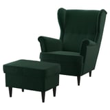 Ensemble chaise à oreilles et pouf en velours vert émeraude. Dos haut, bras roulés, jambes en bois foncé.