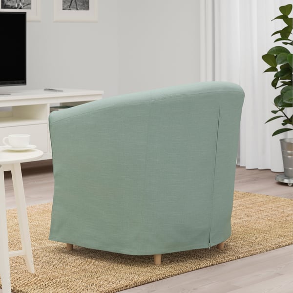 Vue arrière d’un fauteuil TULLSTA confortable, compact et vert clair, parfait pour les petits espaces, avec un dossier rembourré amovible pour le soutien lombaire.