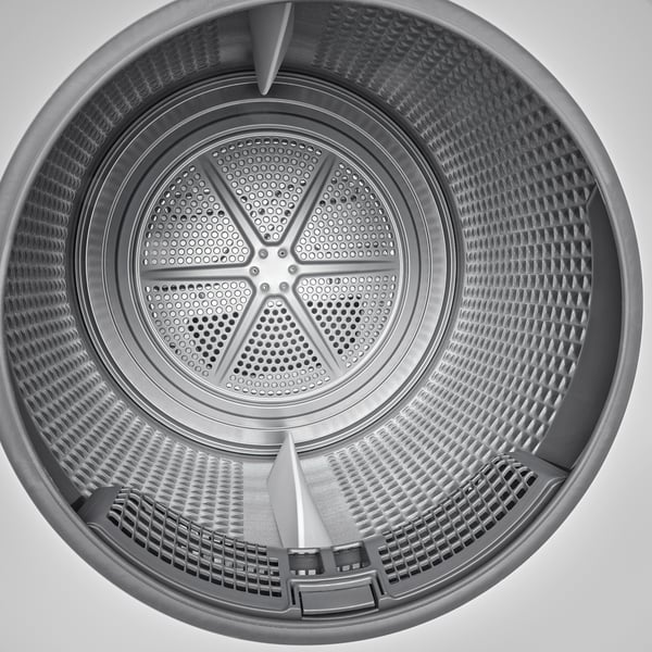 Vue de dessus d’un tambour de machine à laver avec des motifs de grille et des élévateurs pour des résultats de séchage optimaux.