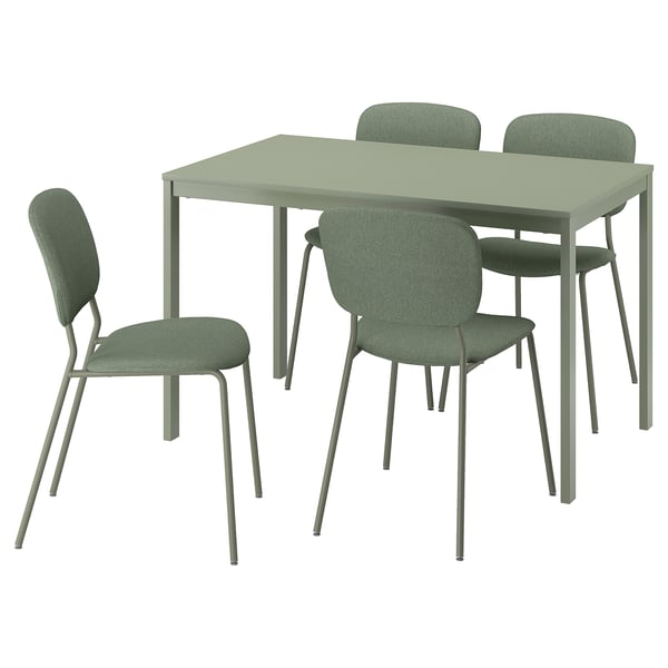 Un ensemble de salle à manger vert avec une table rectangulaire et quatre chaises assorties avec des pieds en métal et des sièges rembourrés.