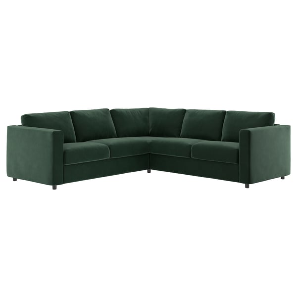 Un canapé d’angle en forme de L vert foncé nommé VIMLE, en velours et mousse de soutien, doté d’un design moderne aux lignes épurées.