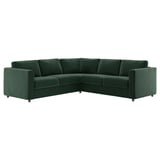 Un canapé d’angle en forme de L vert foncé nommé VIMLE, en velours et mousse de soutien, doté d’un design moderne aux lignes épurées.