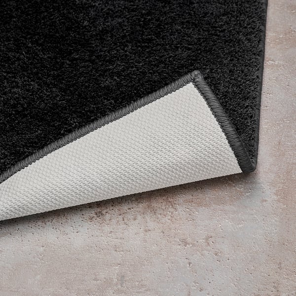 Zwarte badmathoek met witte latex achterkant, met zachte pool en veilige grip.