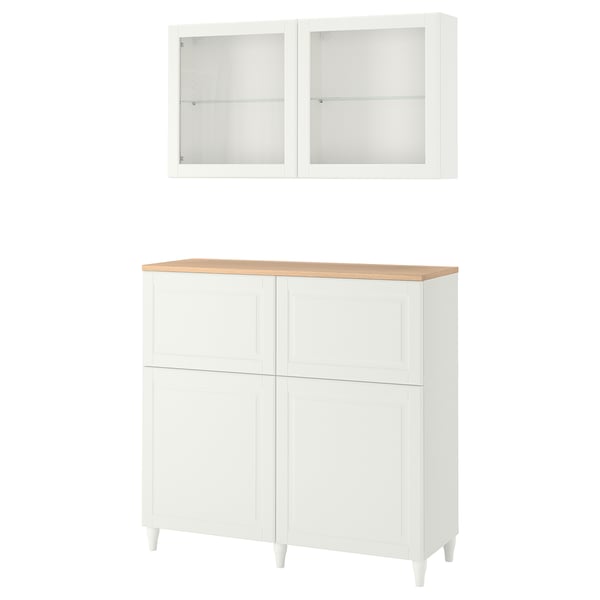 Witte BESTÅ kastenset met glazen deuren, houten blad en opberglades.