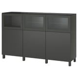 Zwart BESTÅ dressoir met glazen deuren en zwarte poten, voor het privé opbergen van spullen.