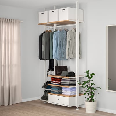 Moderne witte ELVARLI opbergeenheid met kleding, planken en plant. Lang en georganiseerd, perfect voor slaapkamers.