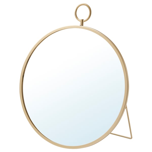 Een goudkleurige GRYTÅS spiegel. Het heeft een ronde vorm met een minimalistisch design. De spiegel kan worden opgehangen of staan.