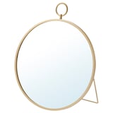 Een goudkleurige GRYTÅS spiegel. Het heeft een ronde vorm met een minimalistisch design. De spiegel kan worden opgehangen of staan.