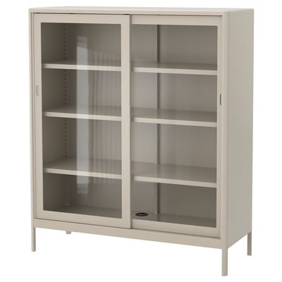 Een IDÅSEN kast in beige. Het heeft glazen schuifdeuren en vier binnenplanken. Het moderne ontwerp is stevig met een metalen frame en gehard glas.
