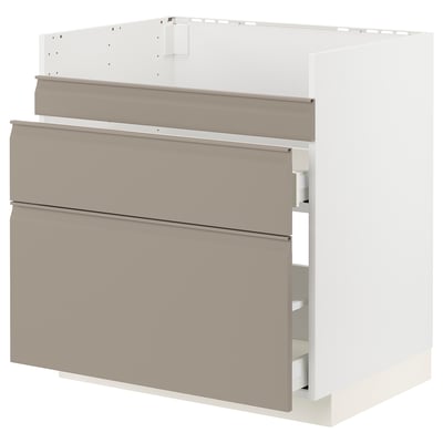 Moderne keukenkast, beige, strak design, drie lades en een plank, gladde handgrepen.