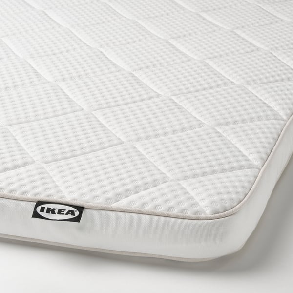 Matrashoek met ikea-label, met zachte witte stof en ruitpatroon, met de nadruk op comfort en kwaliteit.