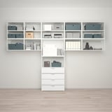 Moderne opbergset: planken en lades met opbergdozen tegen lichte muur, houten vloer.
