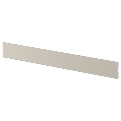 Een beige keukenplint met de naam STENSUND, gemaakt van kunststoffolie en polypropyleen, ontworpen om de opening tussen kasten en de vloer te overbruggen.