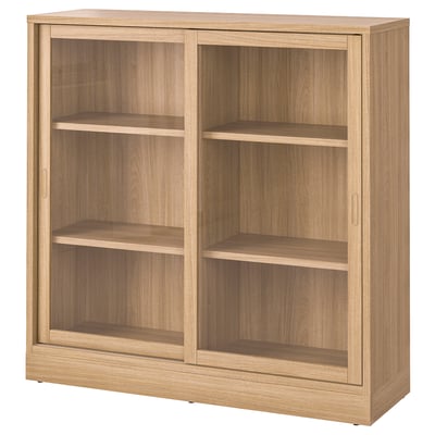 Een TONSTAD houten kast in eiken kleur. Het glazen schuifdeuren, drie planken en een klassiek ontwerp.