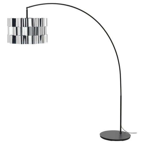 A black ÄLVSTARR floor lamp with a metallic, cylinder-shaped shade. The arched design provides overhead lighting and the base is round and flat.