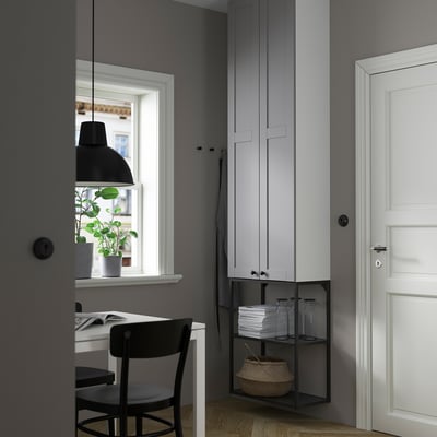 Modern ENHET storage unit with 4 shelves, open metal frame, desk, chair, lamp, and plant.