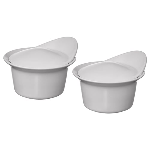Two white stackable ceramic bowls with lids, simple and modern design. Ideal for serving and storing food.