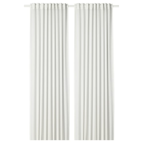 Two white HILJA curtains hang straight, sheer fabric creates soft folds.