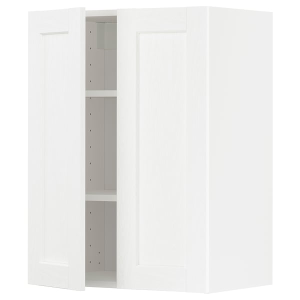 A white METOD kitchen cabinet with one door open, revealing adjustable shelves, and one door closed.