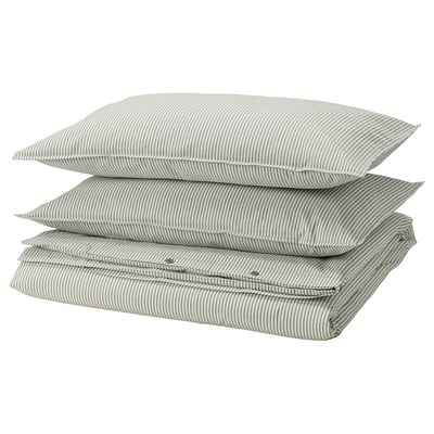 Stacked SOLFIBBLA pillows in white and grey striped cotton. Rectangle shape with zip detail, arranged neatly.