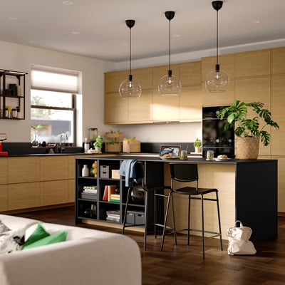 A black STIG bar stool with a metal frame and plastic seat/back, suitable for counter or kitchen island use.