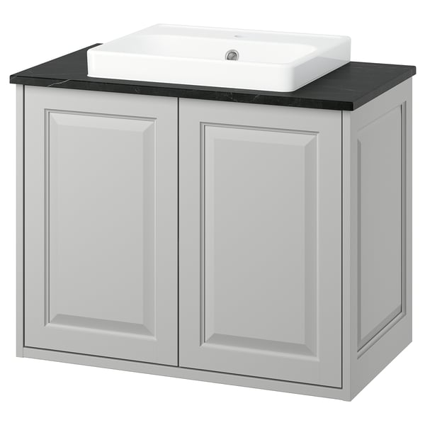 TÄNNFORSEN light grey bathroom cabinet with black marble countertop and white sink.