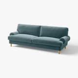 Valnas teal velvet sofa, modern design with rolled arms and light wooden legs.