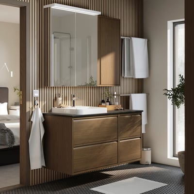 Modern bathroom with large dark wood cabinet, white sink, and large mirror.