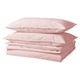 Stacked light pink cotton bedding, including duvet cover and pillowcases.