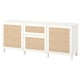 A white BESTÅ sideboard with woven bamboo panels and adjustable shelves, offering ample storage.