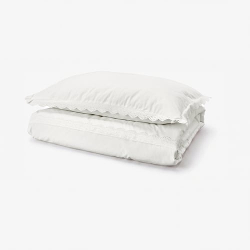 White folded duvet cover with lace trim, 100% cotton.