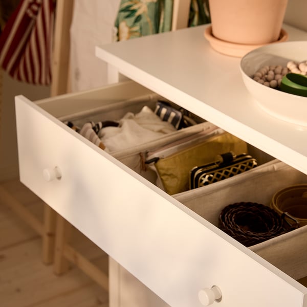 Open white drawer of GULLABERG chest, showing organised socks and accessories.