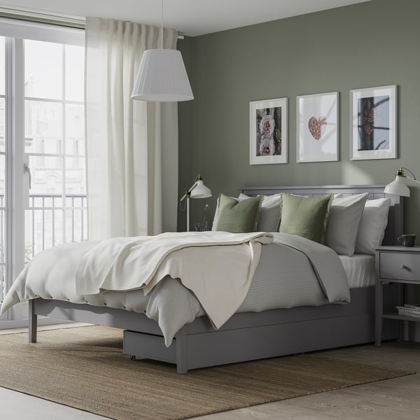 GULLABERG grey bed in cosy bedroom with green accents, art, and natural light.