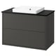Modern black bathroom vanity with sleek drawers and white basin.