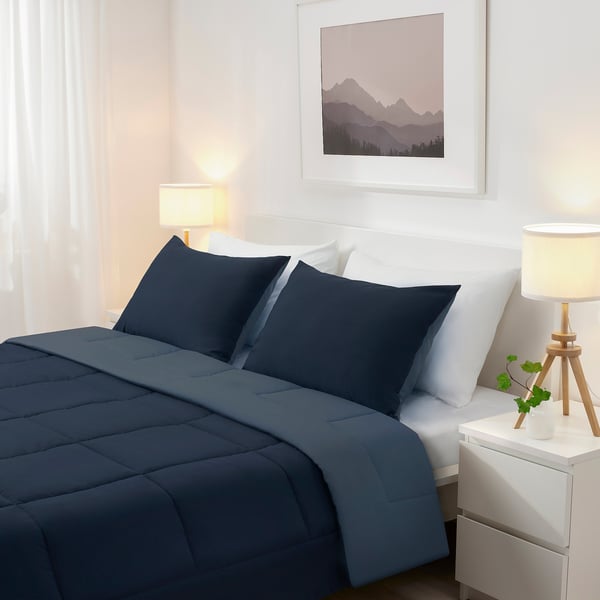 Dark grey HEDFRYLE bed set with lamps and plant, mountain photo.