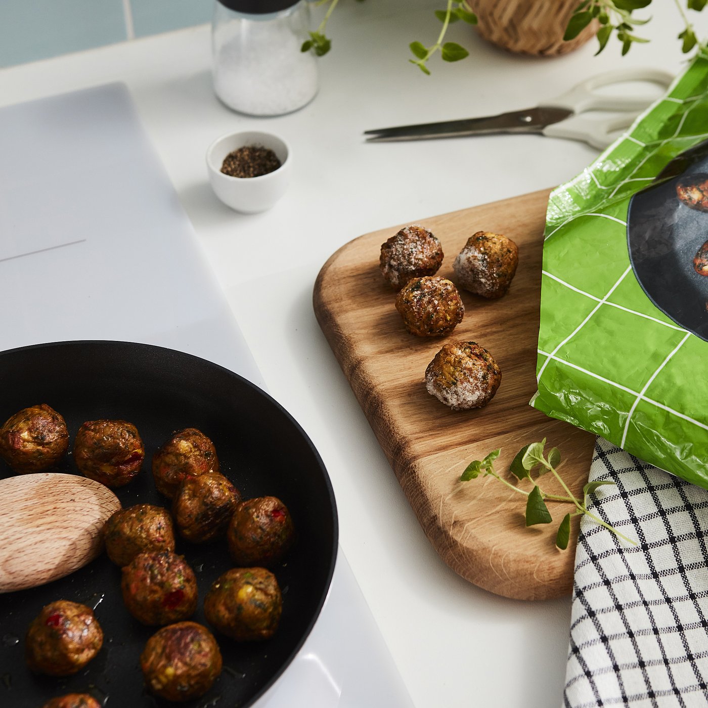 Image shows open package of HUVUDROLL vegetable balls, revealing cooked, round balls with visible veggies on a wooden cutting board.