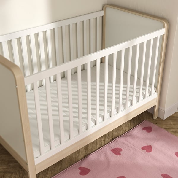 White crib with mattress, pink heart rug, small