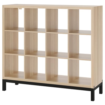 An ikea KALLAX light brown cubed shelf, featuring a metal base, providing a modern and organized storage solution.