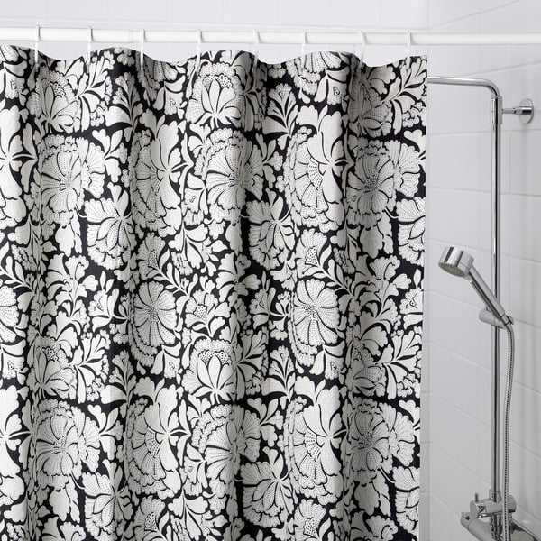 Black & white floral shower curtain in bathroom.