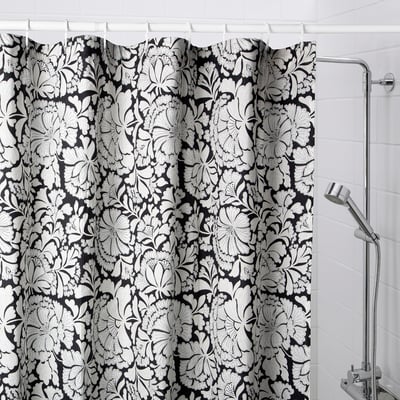 Black & white floral shower curtain in bathroom.