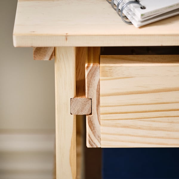 Wooden furniture detail: well-crafted drawer joint, smooth finish.