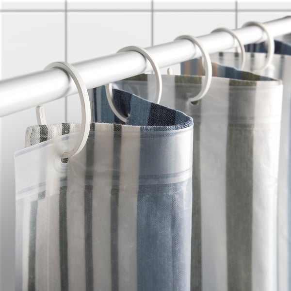 Clear shower curtain rod holds blue striped curtain with hooks.