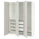 An open white IKEA PAX wardrobe with shelves and storage baskets.