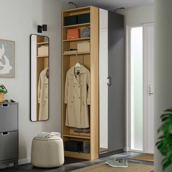 Modern entryway with tall wardrobe, mirrored doors.