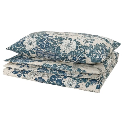 Folded blue floral bedding set with white accents; includes flat sheet, fitted sheet, and pillowcases. Natural, lightweight material.