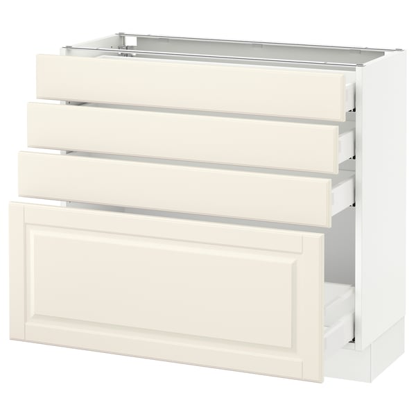 A white SEKTION kitchen cabinet with three drawers and a pull-out tray. It a classic, off-white design with bevelled edges.