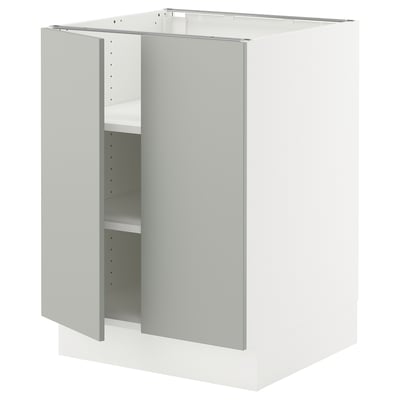 White kitchen cabinet from ikea with light grey door, two shelves, and adjustable hinges.